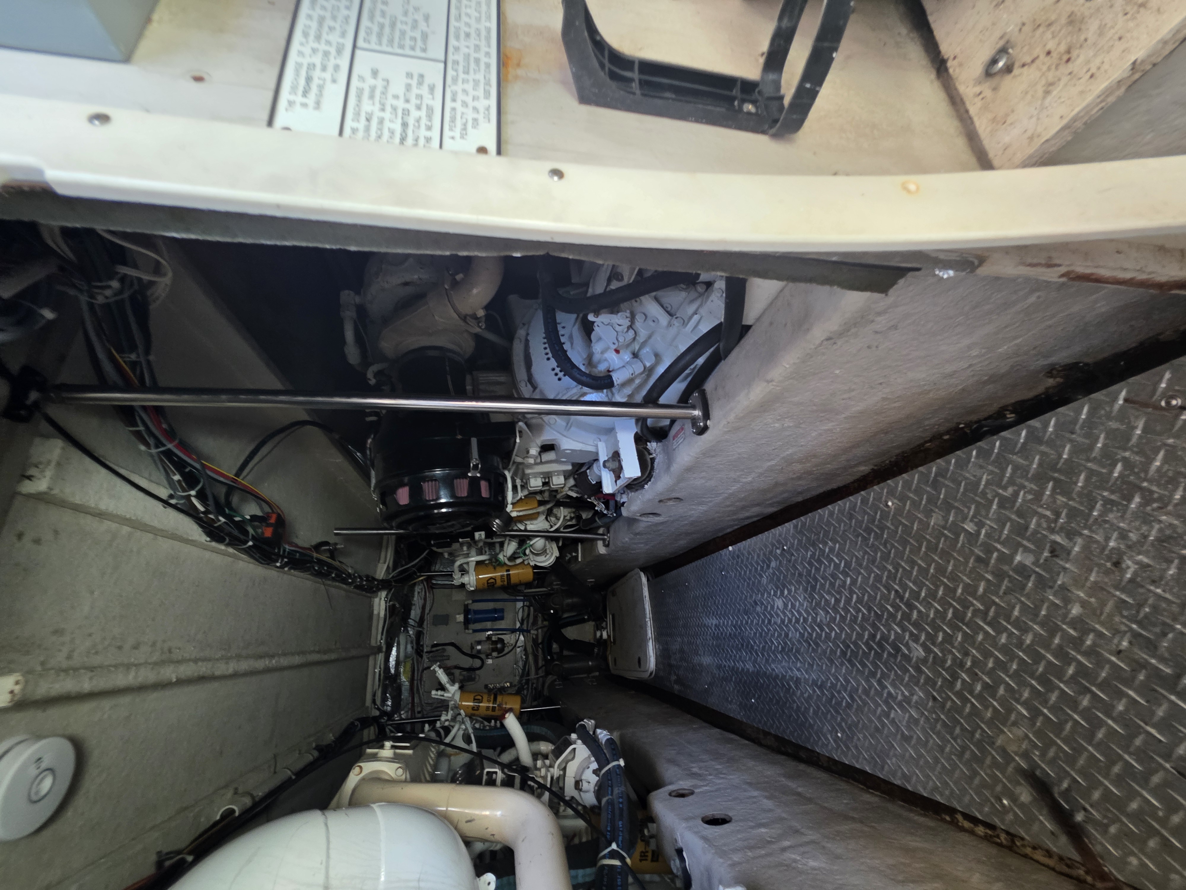Twin marine engines and service equipment inside a vessel engine room